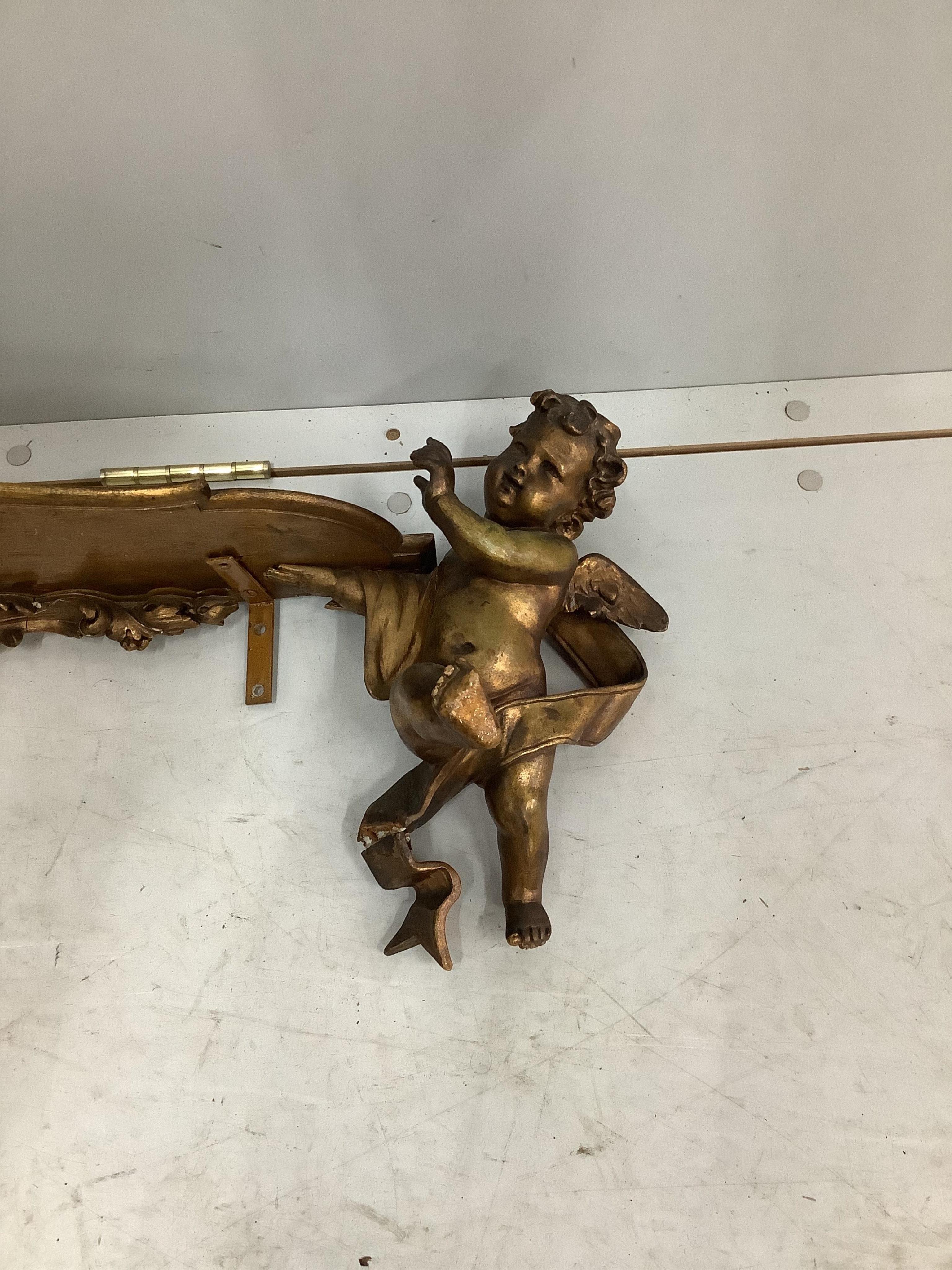 An 18th century style gilt composition cherub wall bracket, width 95cm. Condition - poor to fair